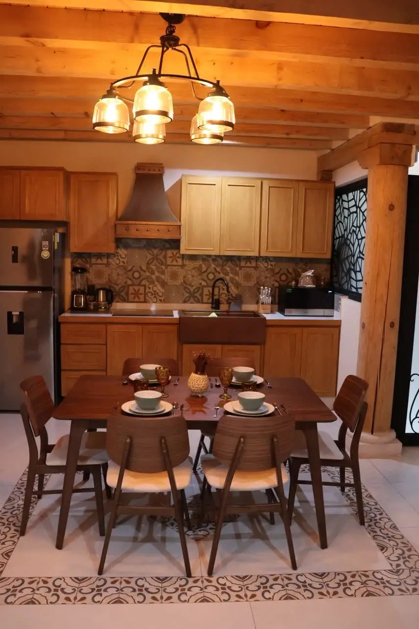 Cocina y comedor con lámpara colgante y campana de cobre